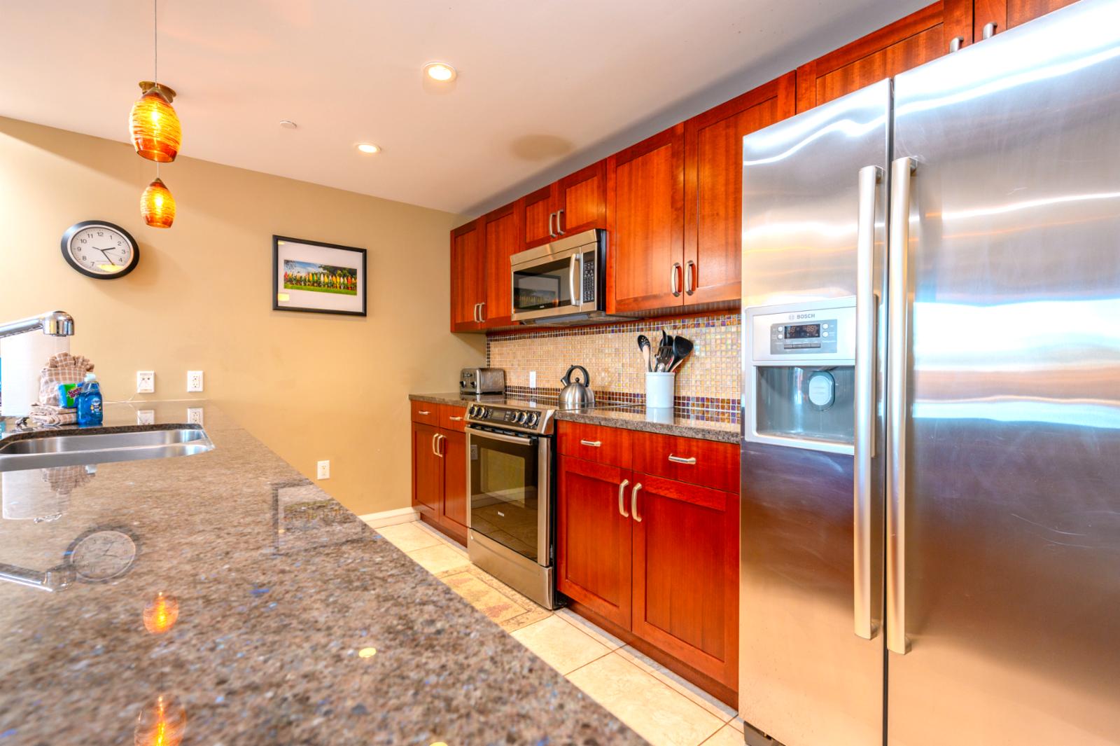 Stainless appliances throughout and generously stocked kitchen