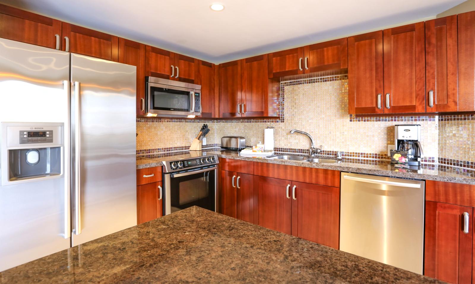 Clean stainless appliances throughout, kitchen is fully stocked with utensils. 