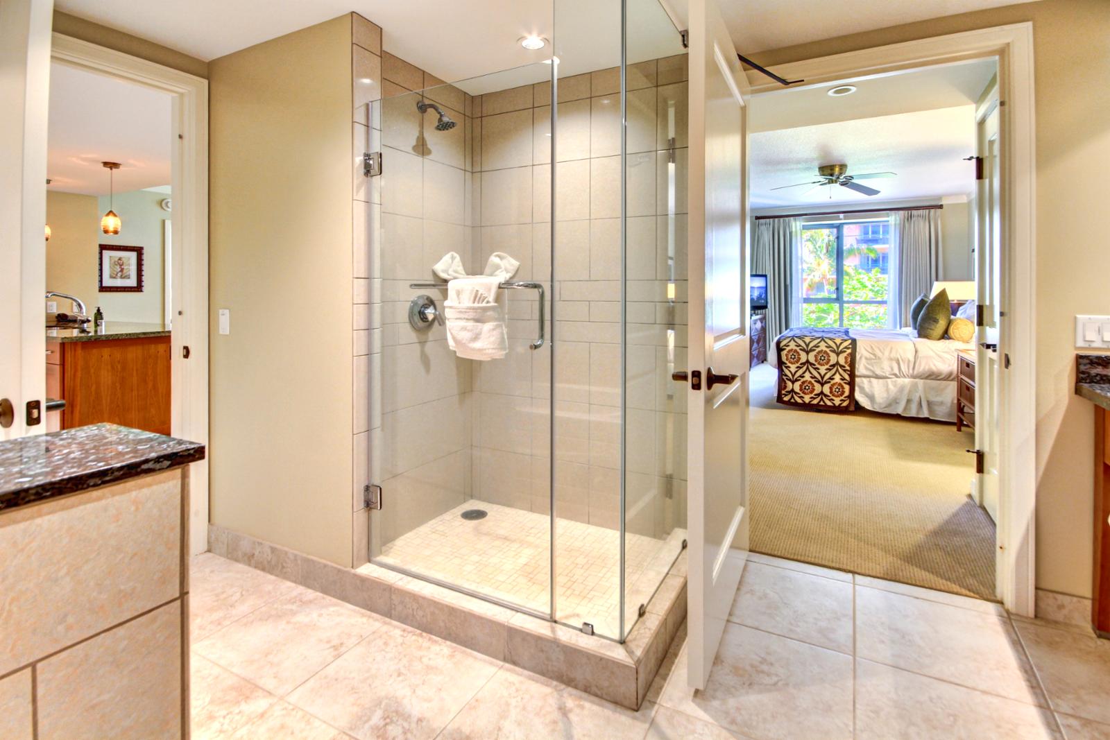 Guest bathroom with separate glassed in shower and separate bathtub. 