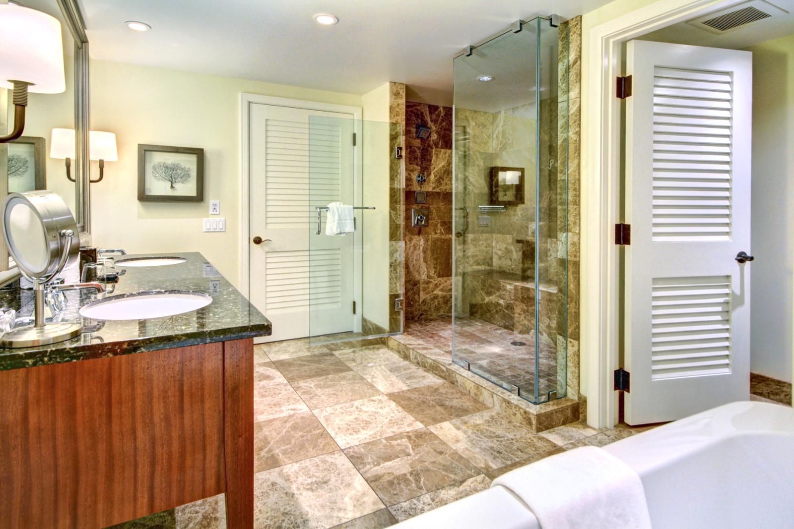 Huge custom shower with dual shower heads and marble tile throughout. 