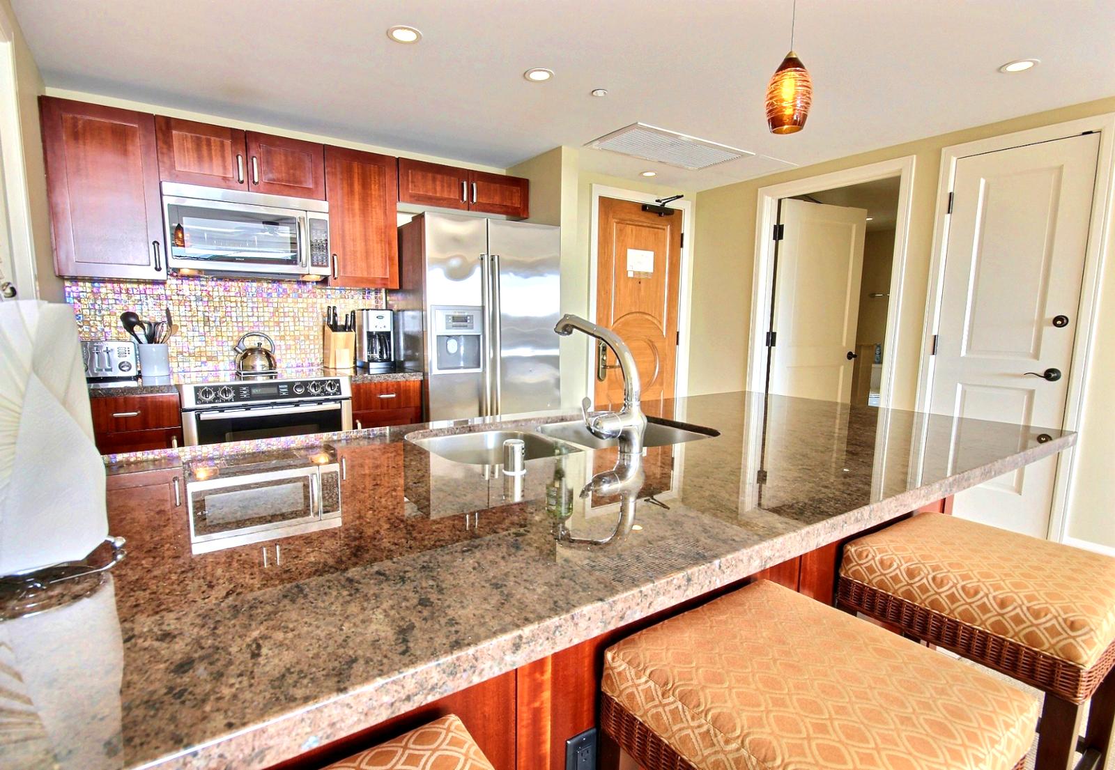 Large granite kitchen counters with bar stools for that casual meal or frozen libation. 