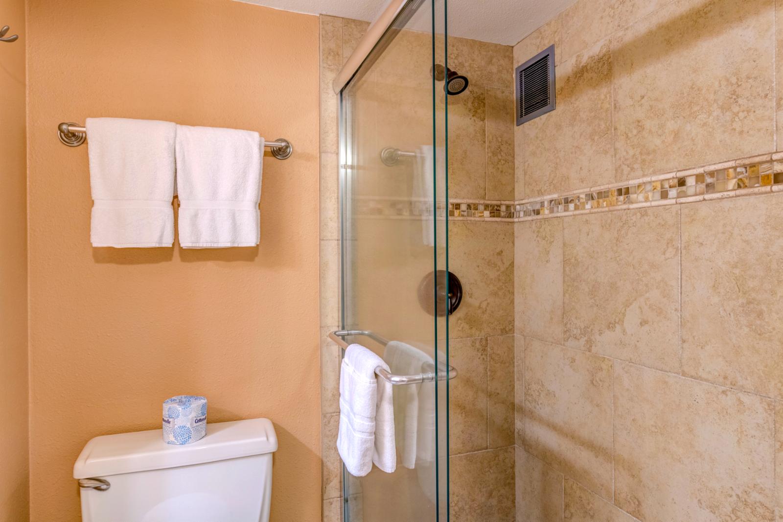 Glass enclosed shower, upgraded lighting and additional storage in hallway