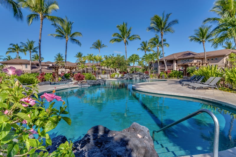 The pool’s shimmering surface reflects the Hawaiian sky, inviting you to swim and unwind. Colony Villas offers a serene setting for relaxation and fun.


