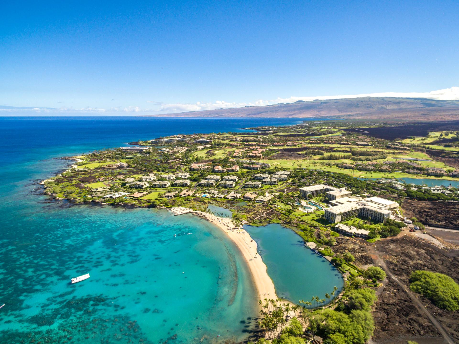 Early morning light casts a soft glow over the lush greens and water features. Waikoloa’s views are a perfect start to any day.