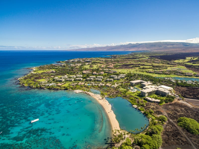Early morning light casts a soft glow over the lush greens and water features. Waikoloa’s views are a perfect start to any day.