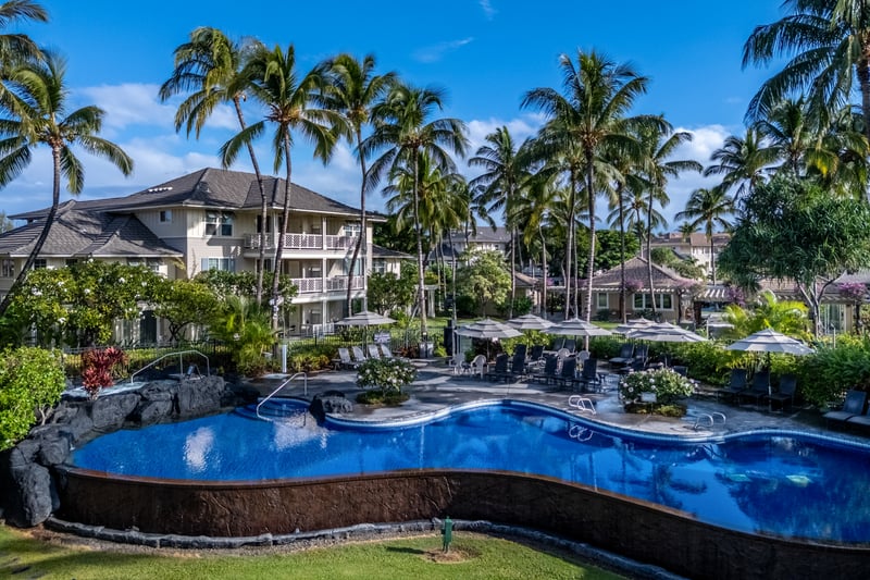 Take a refreshing dip in the tropical lagoon-style pool surrounded by palms and serene resort views.