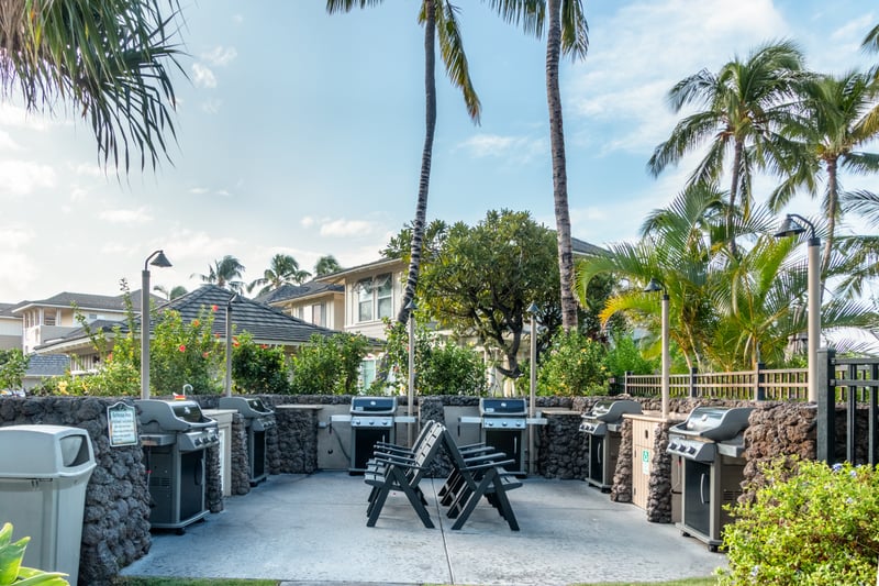 Grill dinner with friends at the community BBQ pavilion, complete with multiple stations and shaded seating.