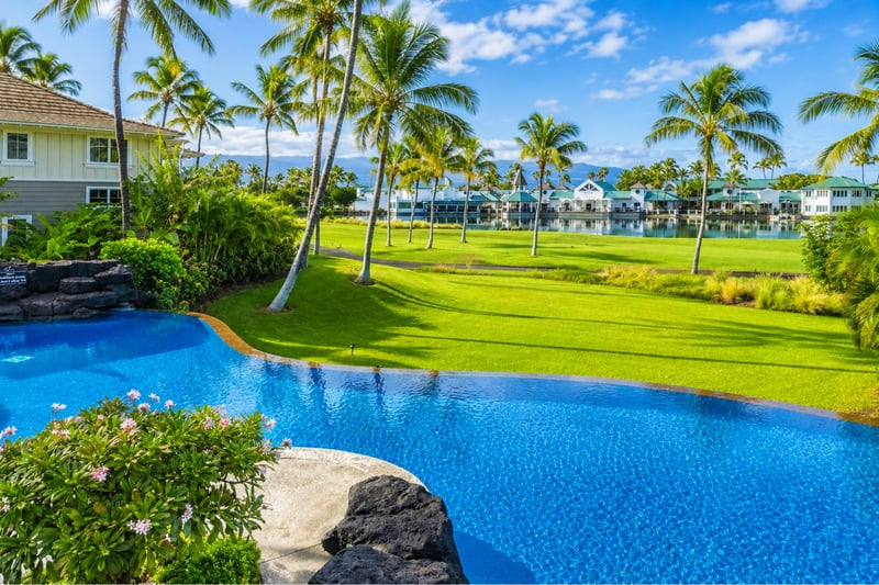 Dive into luxury! The stunning resort infinity-edge pool looks directly out over the lush fairways and Kings' Lake.
