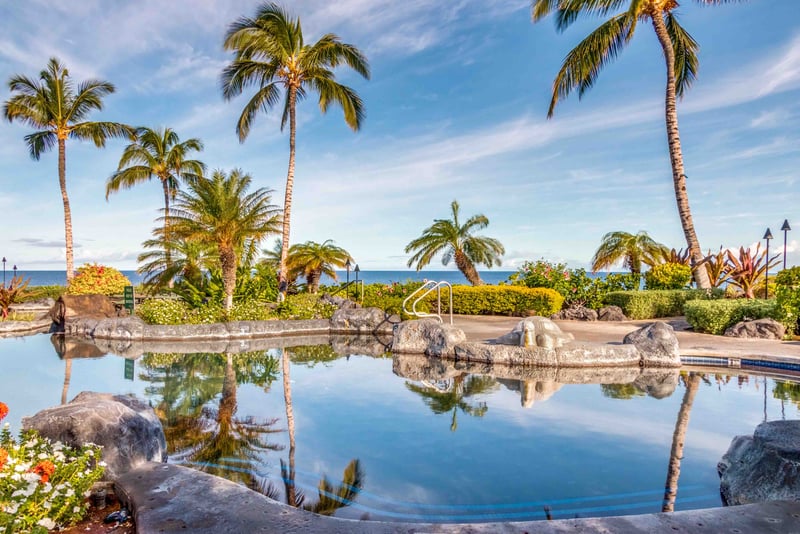 Palm trees frame this tropical oasis, offering shade and style. The pool at Hali‘i Kai is where luxury meets aloha.