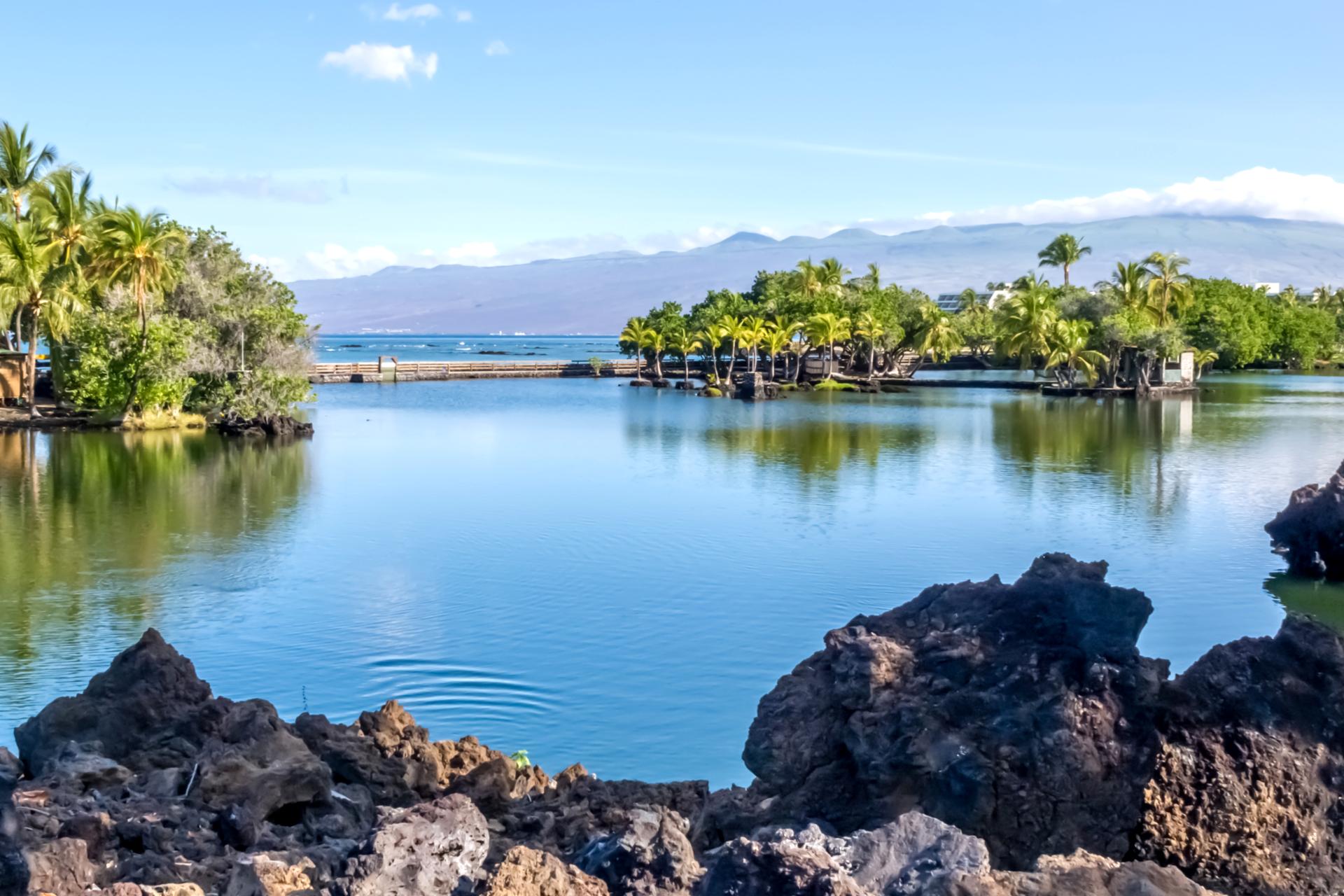 Lava rock-lined lagoons offer crystal waters, tropical foliage, and panoramic island views for pure relaxation