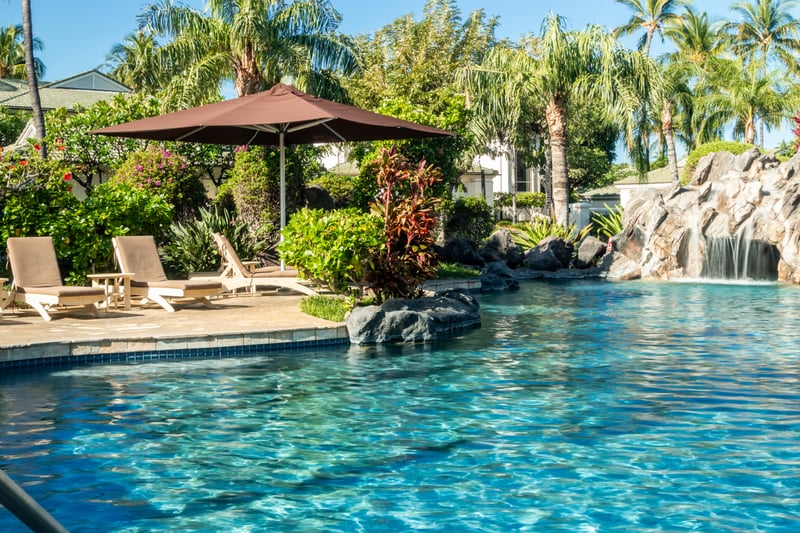 Escape to paradise with lagoon-style pools, waterfalls, shaded loungers, and tropical foliage all around you
