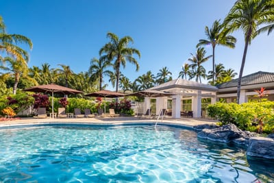 Relax poolside under swaying palms with shaded pavilions, crystal-clear water, and tropical resort scenery