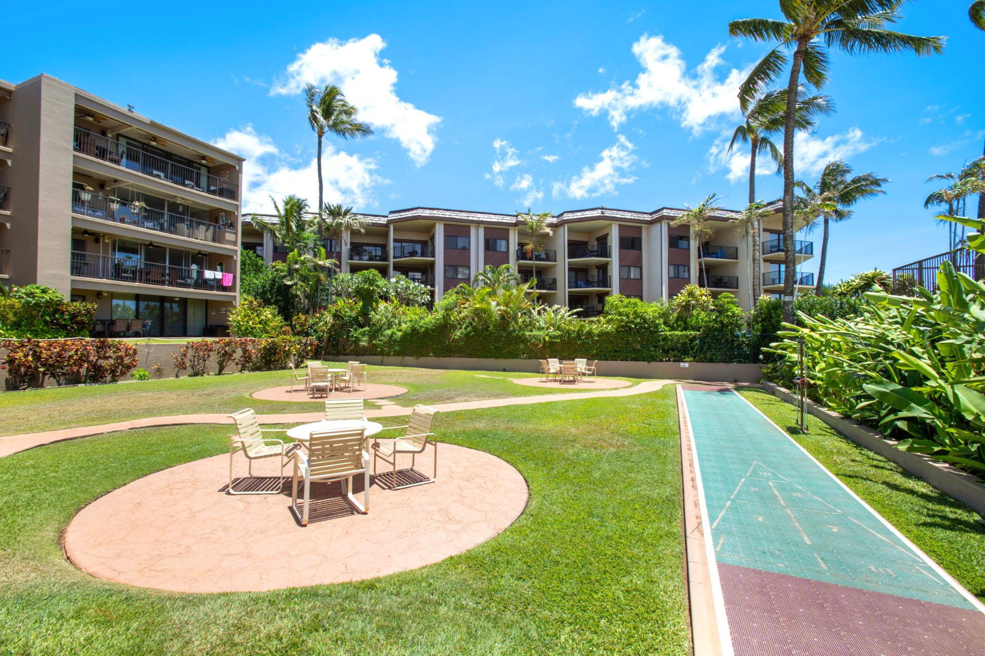 Relax in Hale Ono Loa’s tropical courtyard with shuffleboard, outdoor dining tables, lush gardens & Maui breezes
