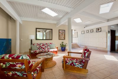 Welcome to Hale Ono Loa: bright open-air lobby with island décor, natural light, seating & warm Maui hospitality