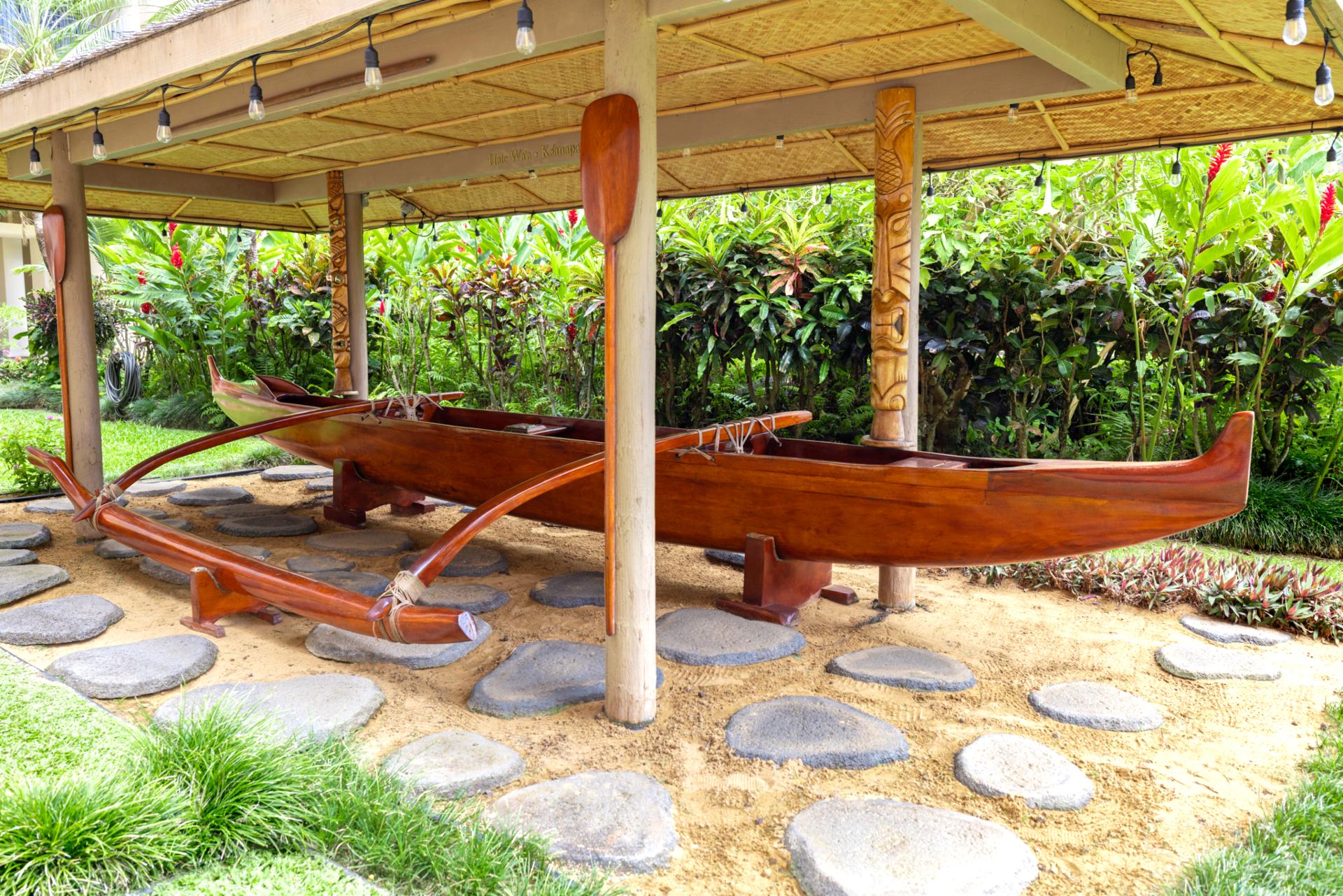 Admire Kaanapali Shores cultural touches, including the traditional Hawaiian outrigger canoe displayed on the lush resort grounds.