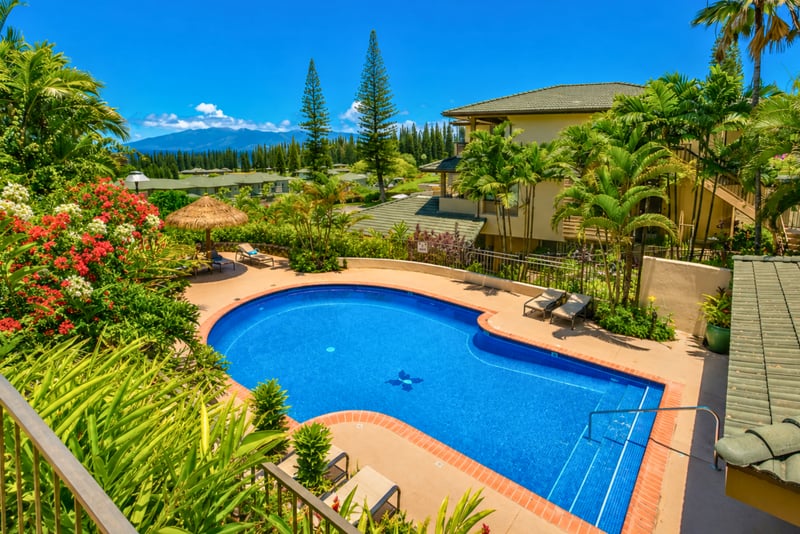 The sparkling pool at Kapalua Golf Villas offers a refreshing oasis surrounded by tropical palms. It is the perfect spot to cool off and unwind after a day of island adventures.
