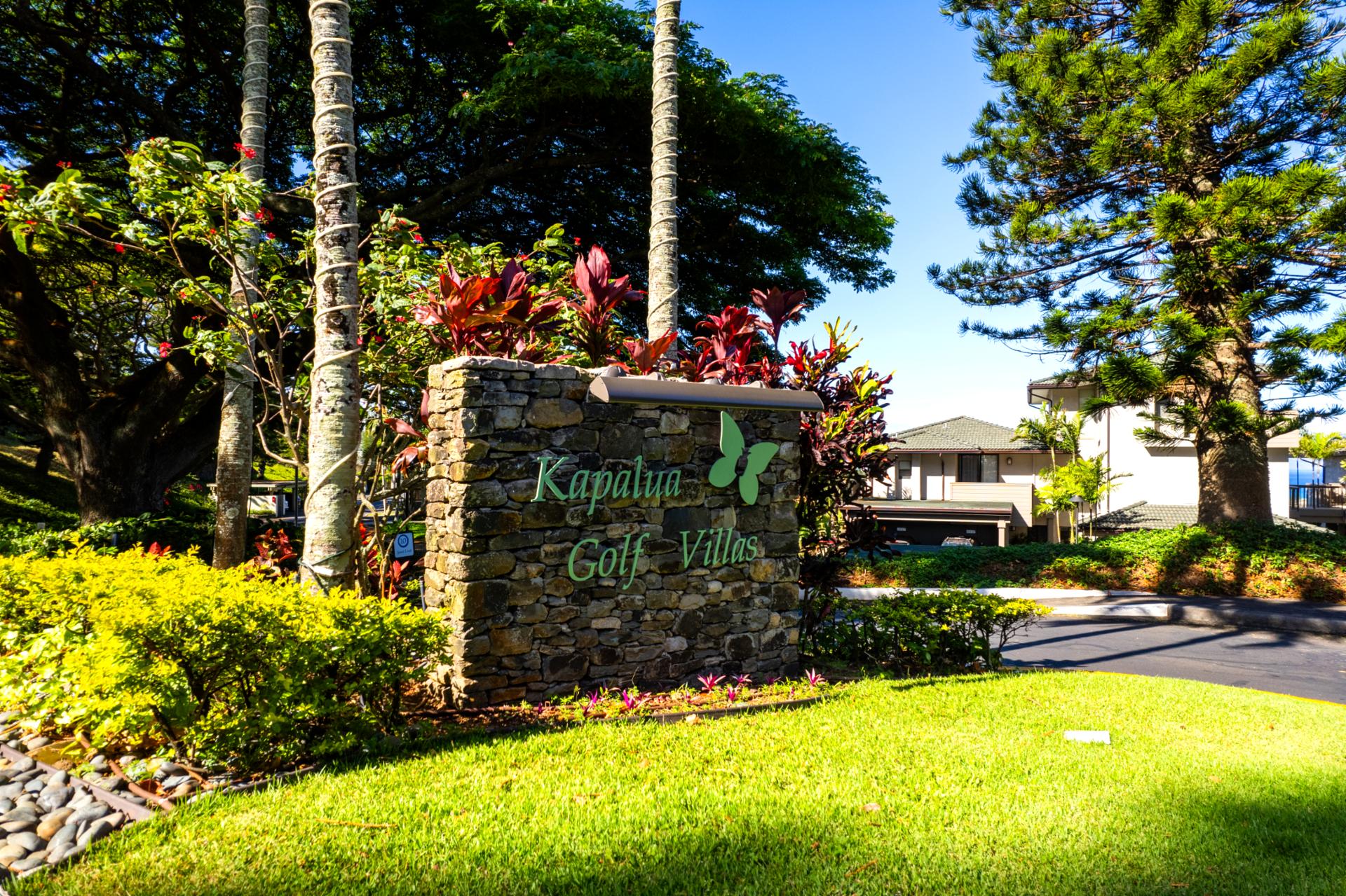 Step into the welcoming entrance of Kapalua Golf Villas, where Hawaiian hospitality greets you at every turn. The lush landscaping sets a warm, tropical tone.