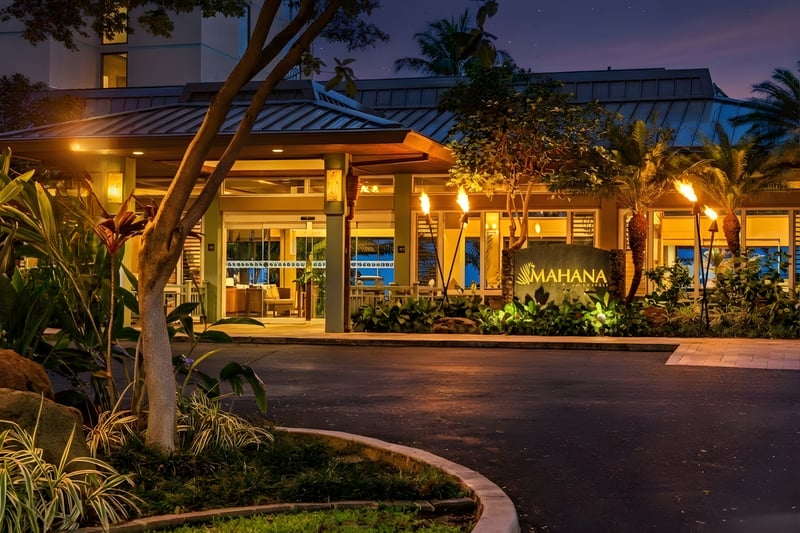 Nestled amid tropical landscaping, this serene entrance invites you into a beachfront haven with stunning ocean views just steps beyond the doors.