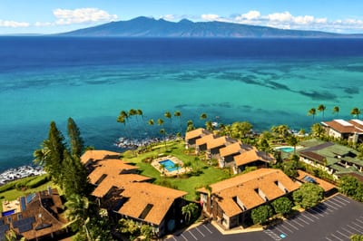 Aerial view of Mahina Surf — the oceanfront complex and its central pool courtyard, with West Maui mountains and Molokai across the channel