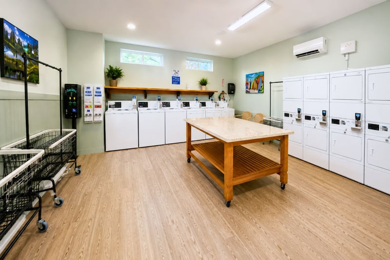 On-site guest laundry facility with multiple washers, folding station & added convenience for extended stays