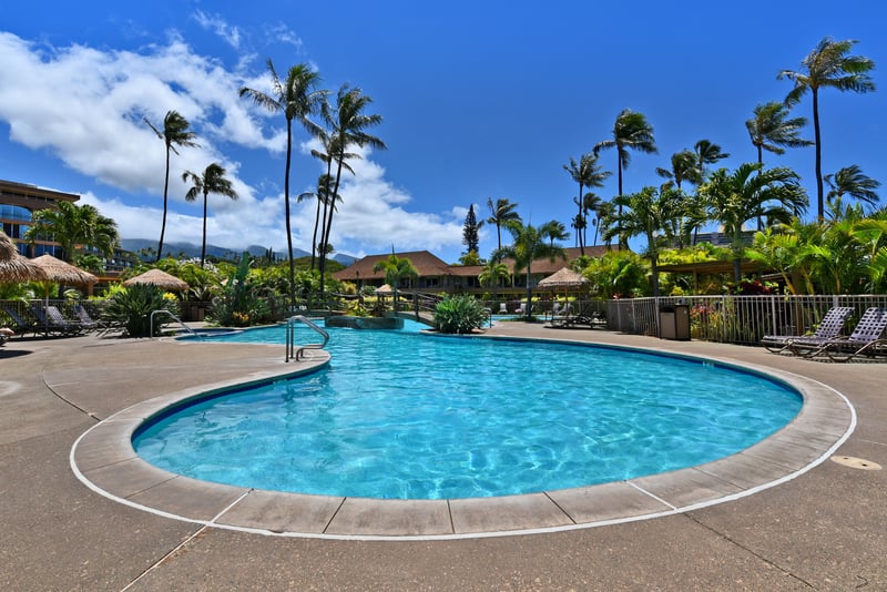Resort-style pool oasis surrounded by tropical gardens, swaying palms & crystal-clear tranquil waters