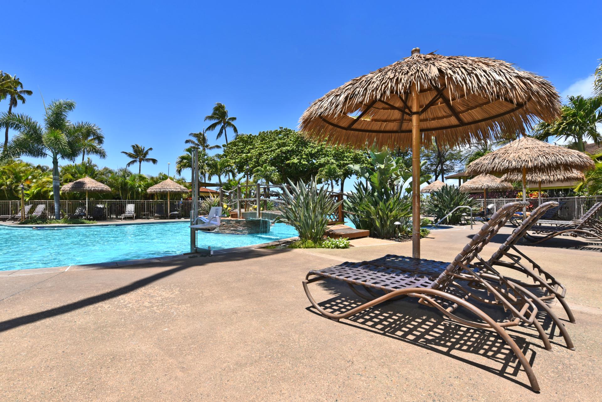 Luxury poolside escape with thatched cabanas, tropical gardens & serene crystal waters