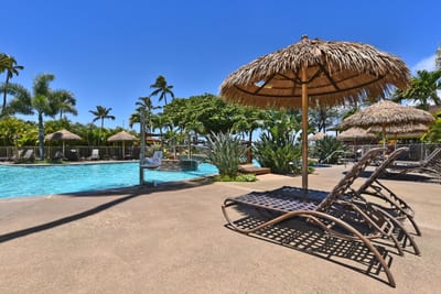 Luxury poolside escape with thatched cabanas, tropical gardens & serene crystal waters