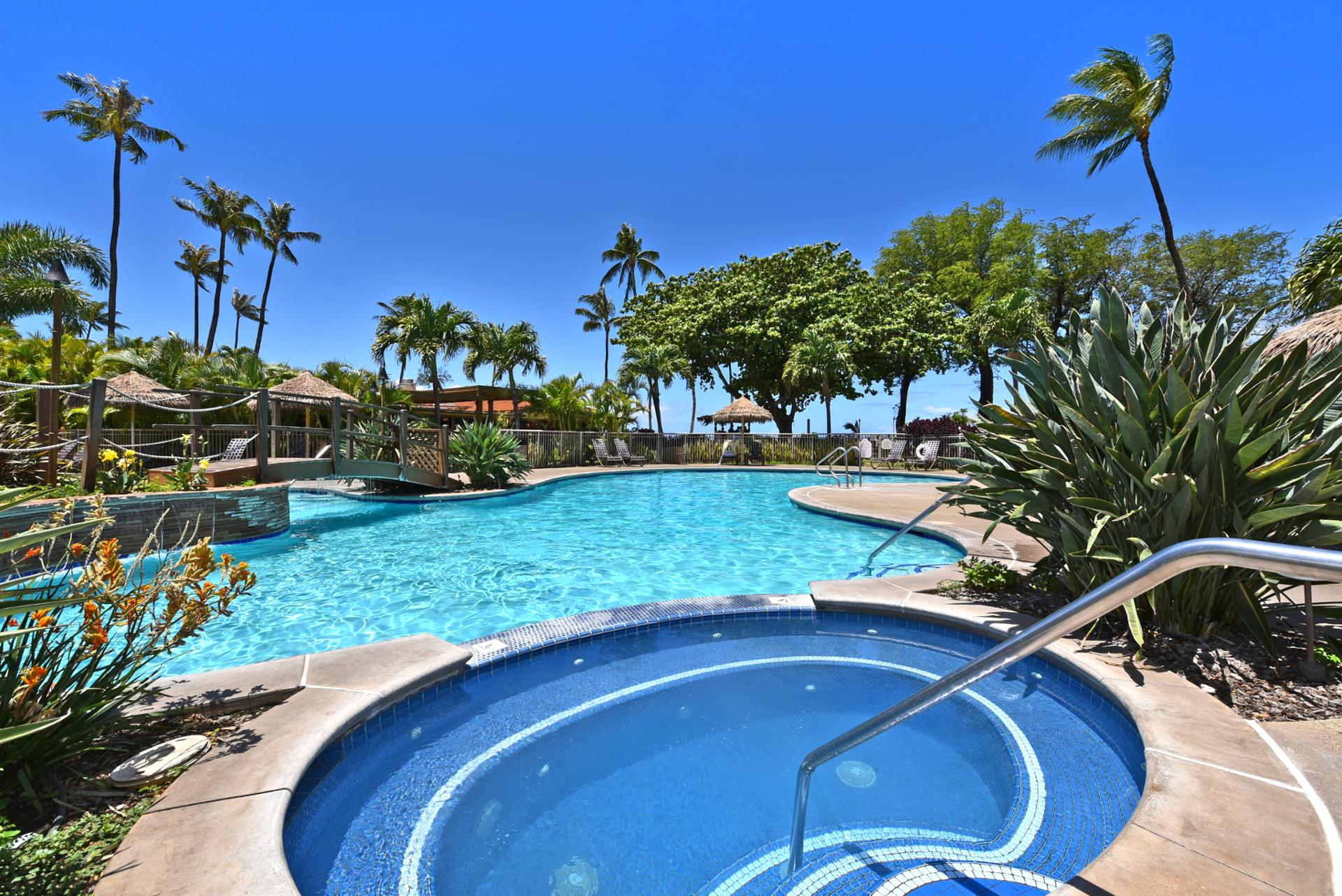 Exclusive poolside retreat with tropical bridges, lush gardens, cabana lounges & crystal-clear waters