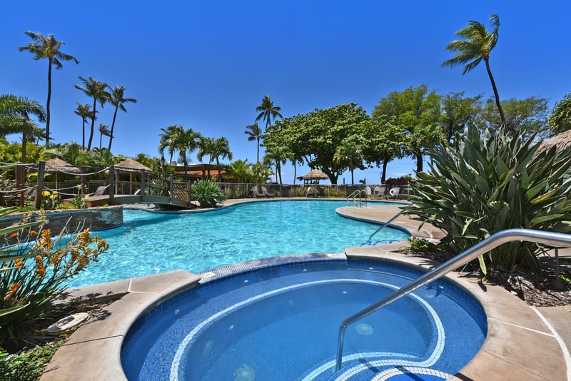 Exclusive poolside retreat with tropical bridges, lush gardens, cabana lounges & crystal-clear waters