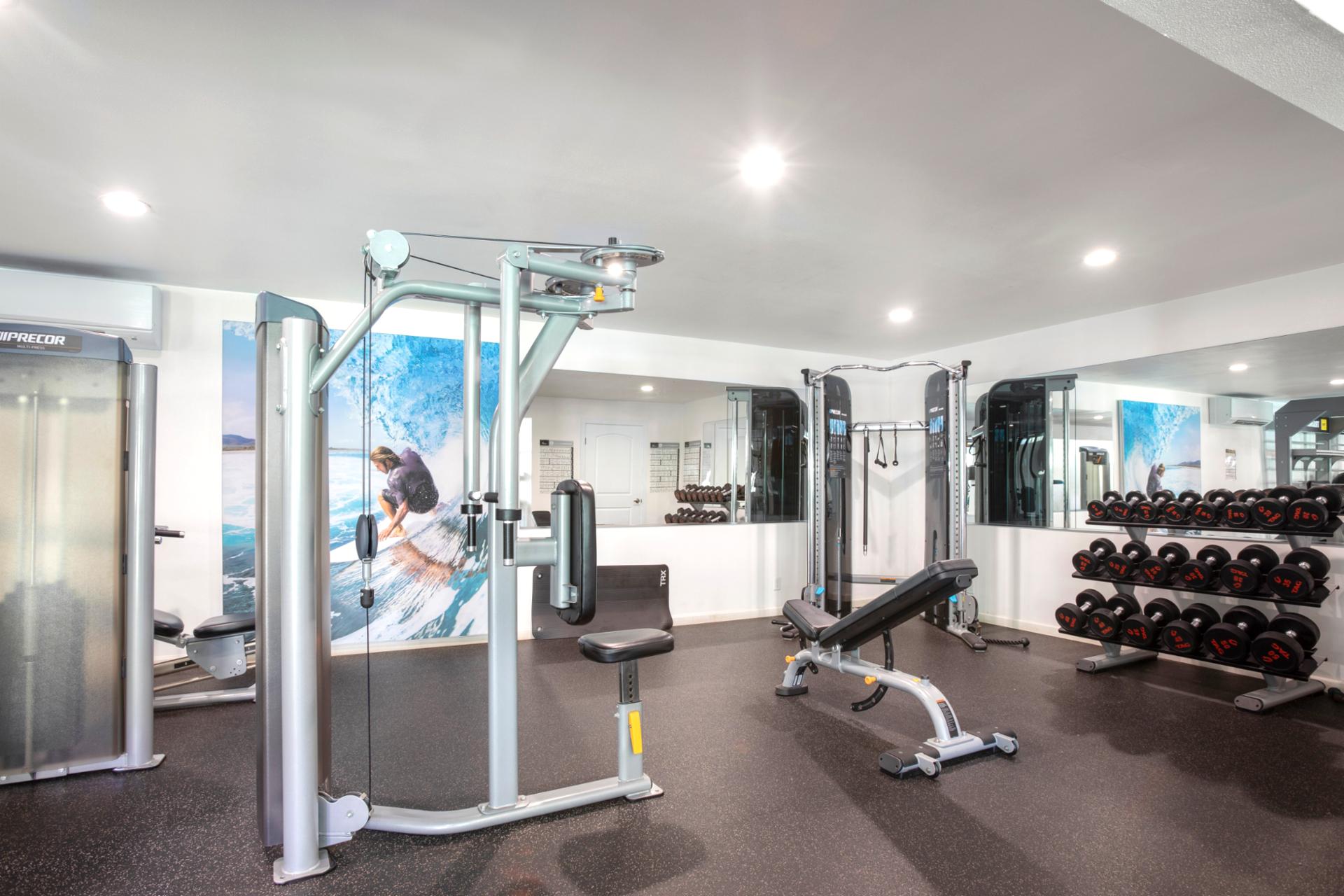 Resort gym offering state-of-the-art equipment, free weights & open-air inspired workout space for guests