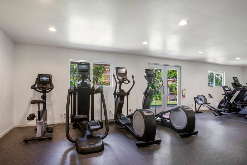Private resort fitness center with cardio, strength training & bright natural light for energized island workouts
