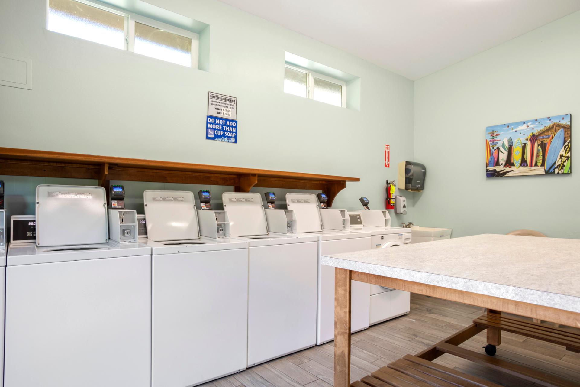On-site guest laundry facility with multiple washers, folding station & added convenience for extended stays