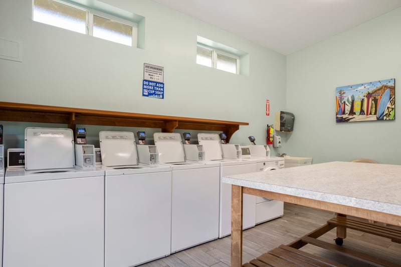 On-site guest laundry facility with multiple washers, folding station & added convenience for extended stays