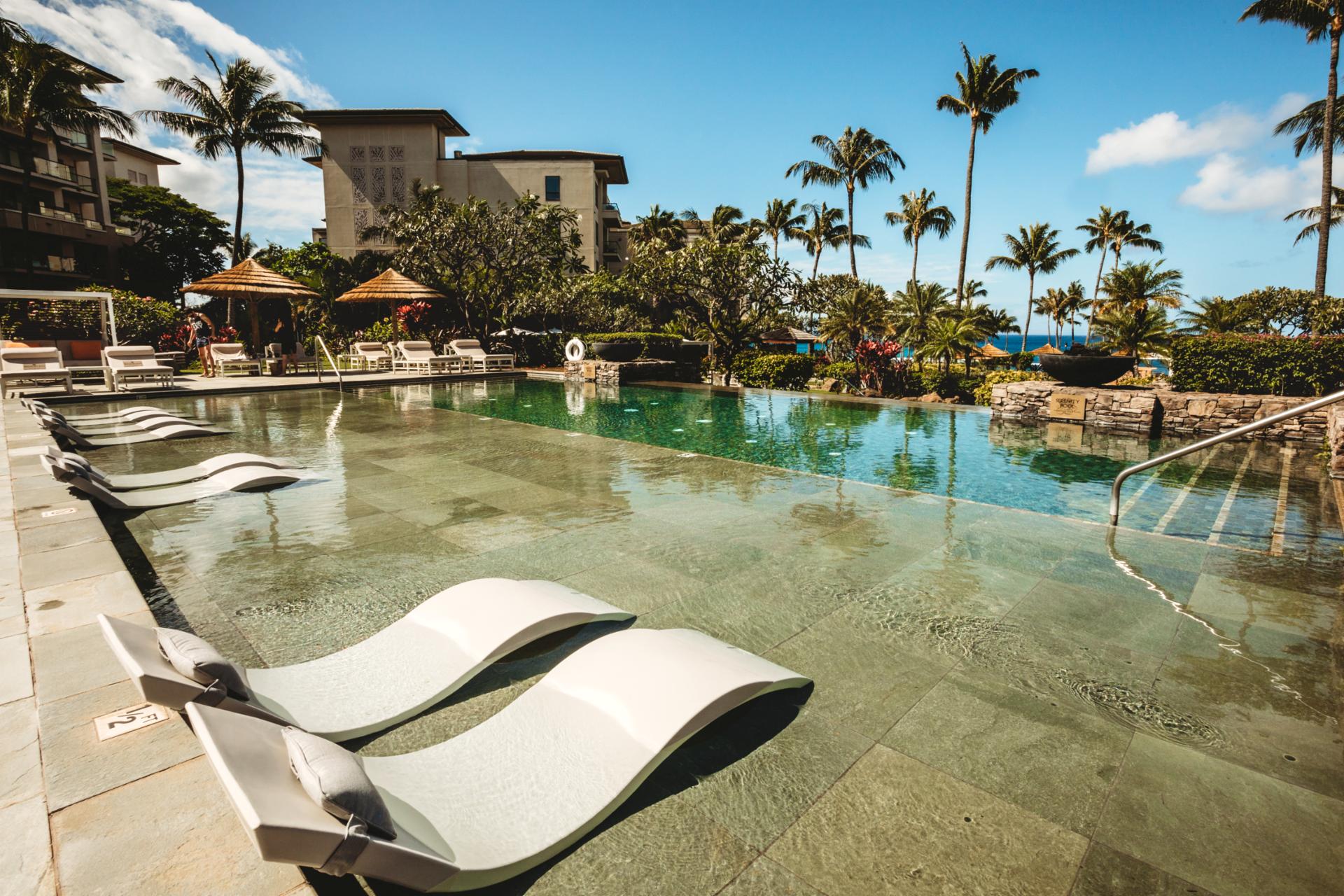 Bask under Maui’s sun on in-water loungers, steps from palm-lined pools, luxury amenities & ocean breezes