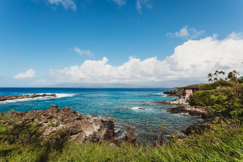 Gaze out over Maui’s dramatic rocky coastline where crystal waves meet lush cliffs & endless Pacific views