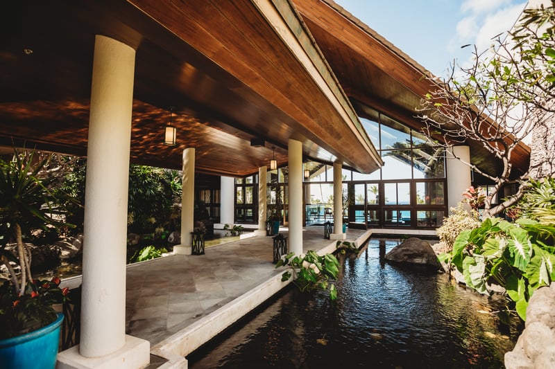 Stroll peaceful garden pathways with tranquil koi ponds, lush tropical plants & calming resort water features