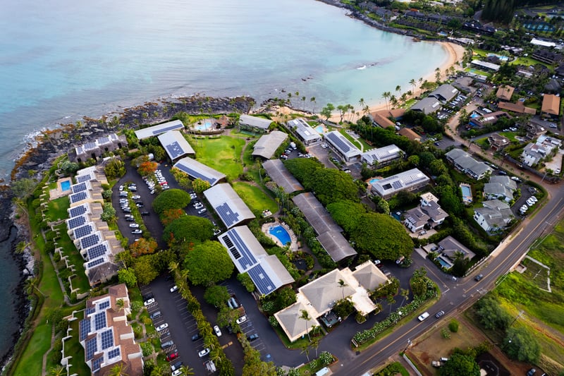 Aerial views showcase Napili Shores’ oceanfront setting, tropical gardens & prime beachfront location