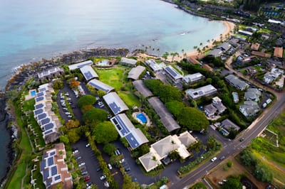 Aerial views showcase Napili Shores’ oceanfront setting, tropical gardens & prime beachfront location