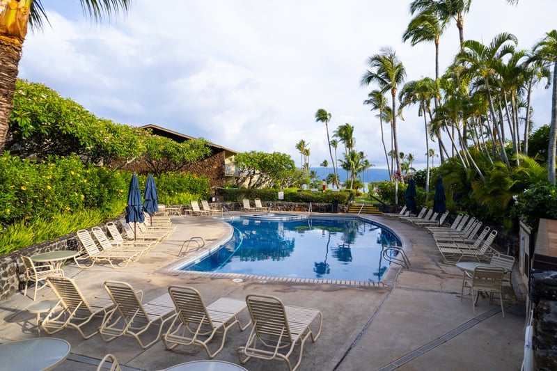Lounge poolside surrounded by tropical gardens & ocean breezes at Napili Shores Resort in Maui