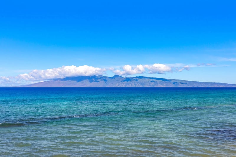 Experience Maui's oceanfront luxury: crystal waters, island views, and unforgettable sunsets. Book your escape!