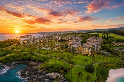 Witness stunning Maui sunsets above our oceanfront resort, where golden skies meet lush tropical paradise