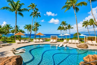 Lounge at our oceanfront serenity pool, with in-water loungers, private cabanas & sweeping Kapalua Bay views