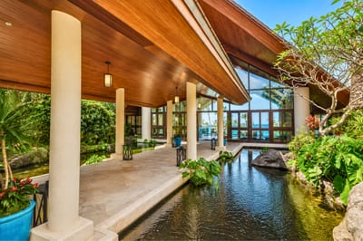 Stroll peaceful garden pathways with tranquil koi ponds, lush tropical plants & calming resort water features