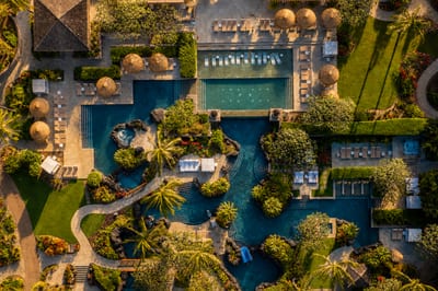 Children's pool area, with a slide, next to relaxing chairs for adults and a pool bar - perfect for the whole family.