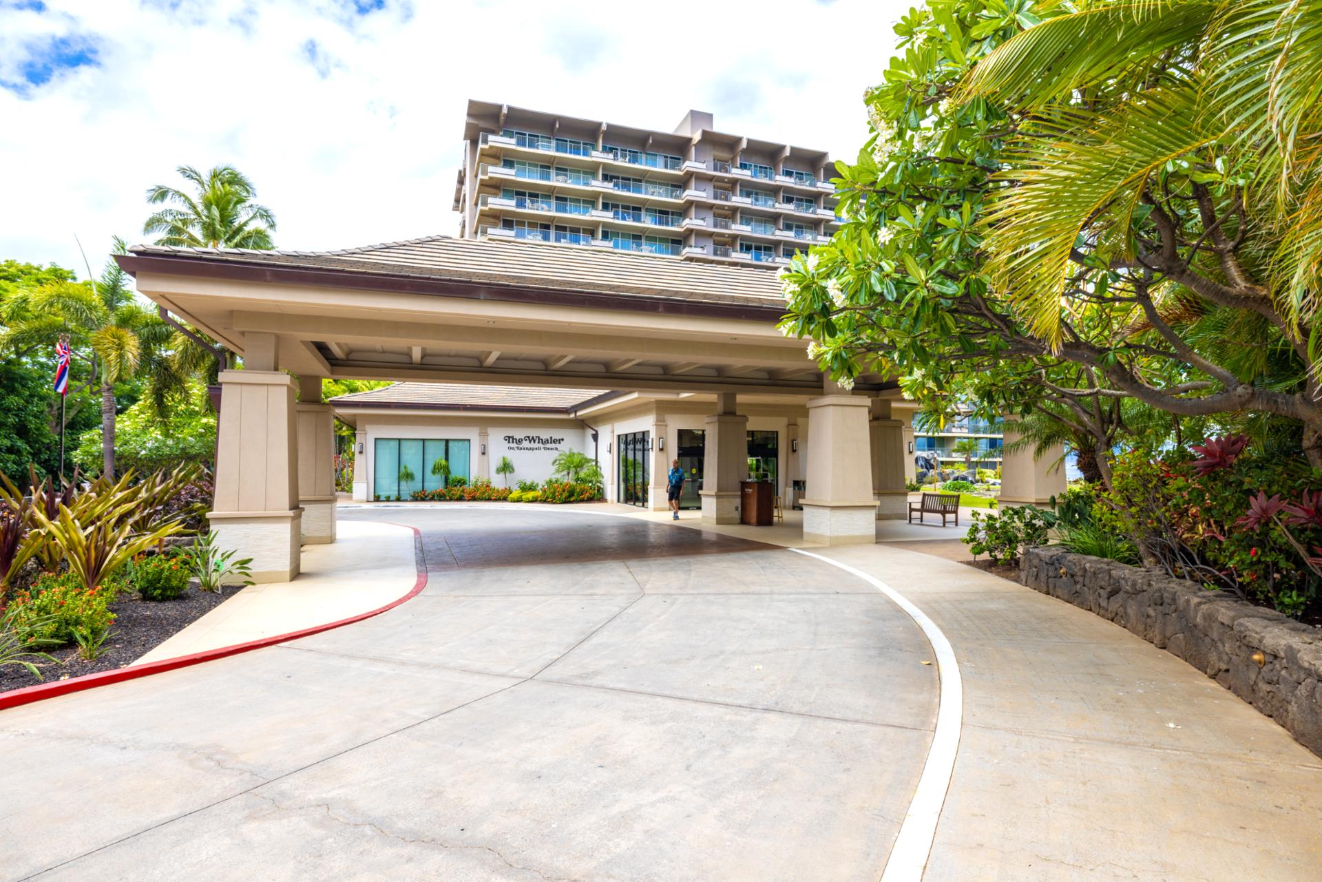 Private resort entrance with lush tropical landscaping, exclusive arrival drive, elegant design, and luxury beachfront access