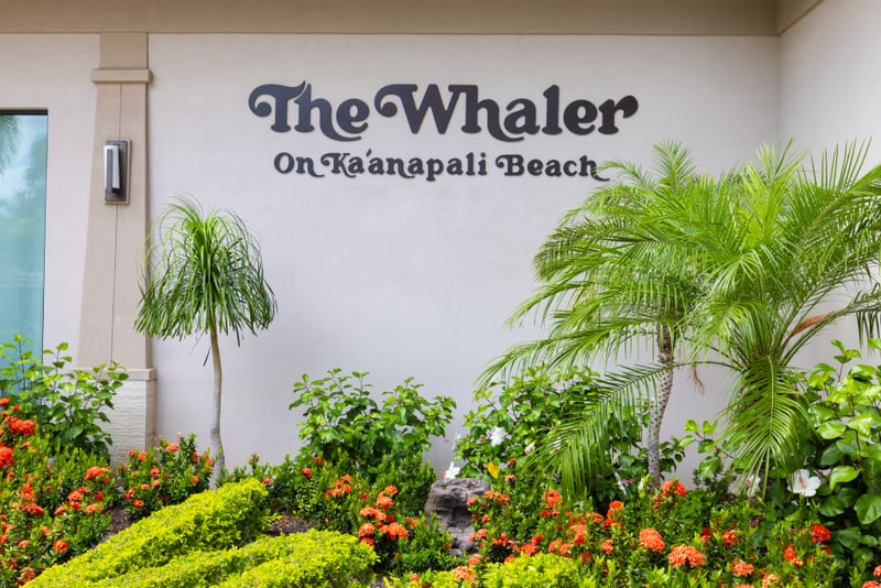 Sophisticated resort entrance with lush landscaping, tropical foliage, private driveway & direct access to beachfront living