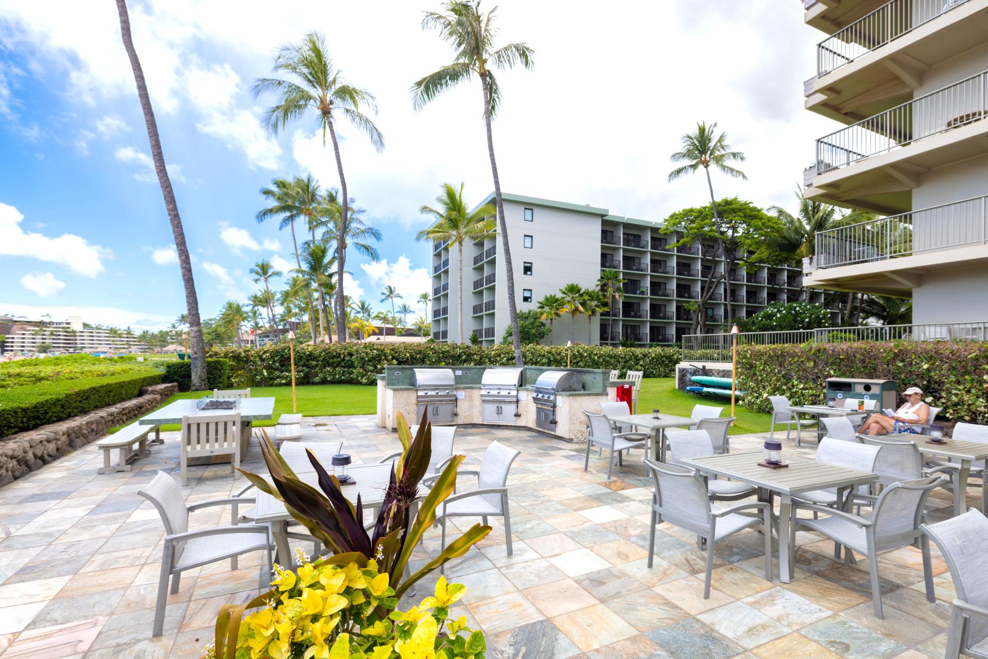 Beachfront BBQ grills with stainless steel stations, outdoor dining area, tropical gardens, ocean views & relaxed island living