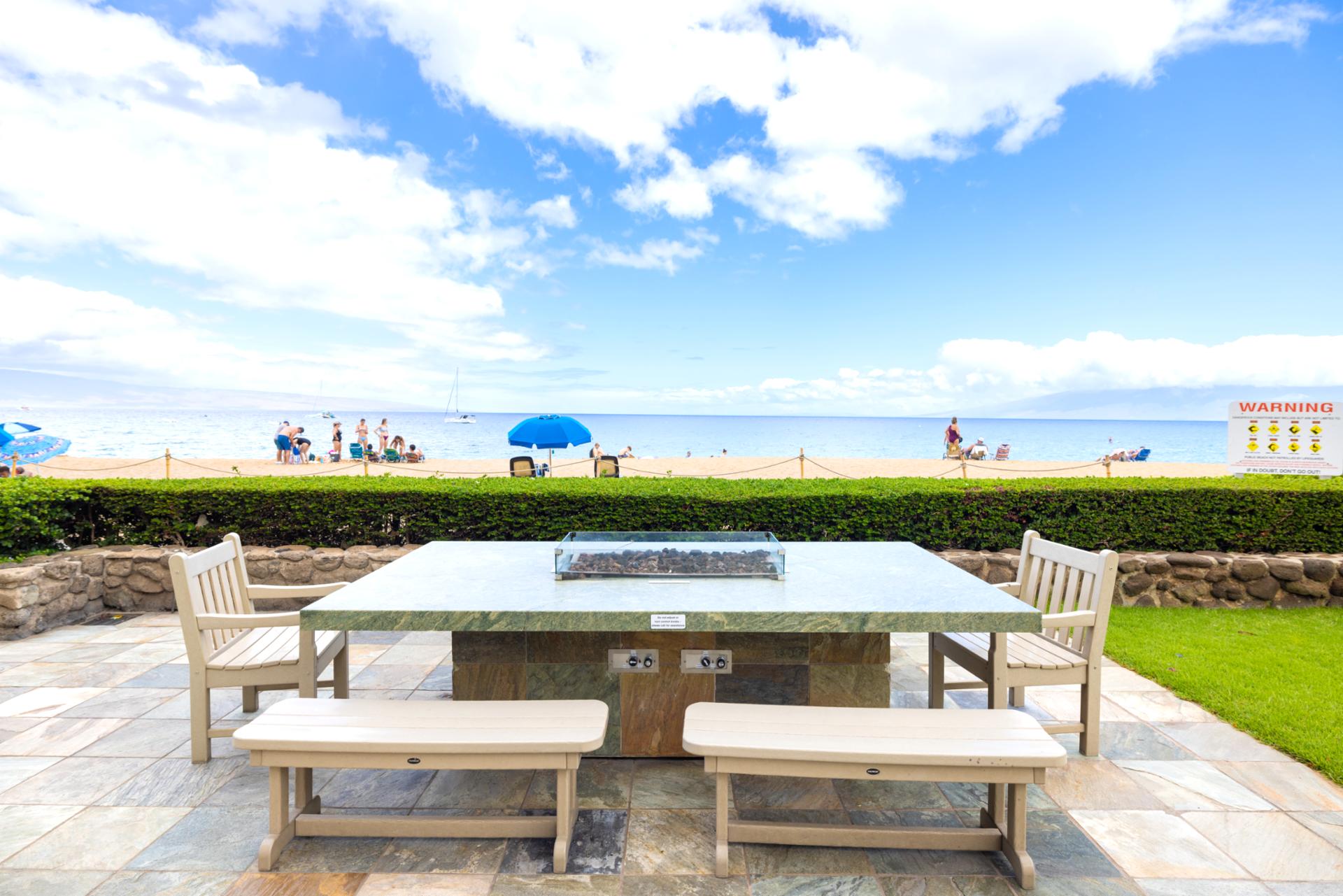 Beachfront BBQ pavilion with panoramic ocean views, outdoor dining, tropical landscaping, seating & relaxed island atmosphere