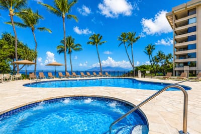 Oceanfront pool deck with luxury loungers, lush gardens & direct access to pristine white sand beaches