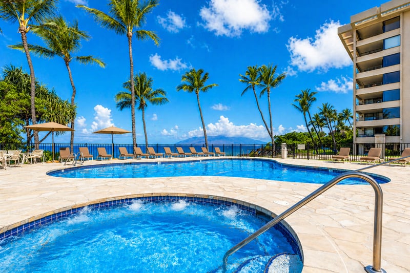 Oceanfront pool deck with luxury loungers, lush gardens & direct access to pristine white sand beaches